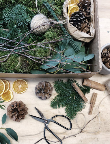 Diy christmas wreath kit containing moss base, twine, wires, birch twigs, spruce, eucalyptus, pistachio and natural decorations: cinnamon sticks, orange slices abd pine cones